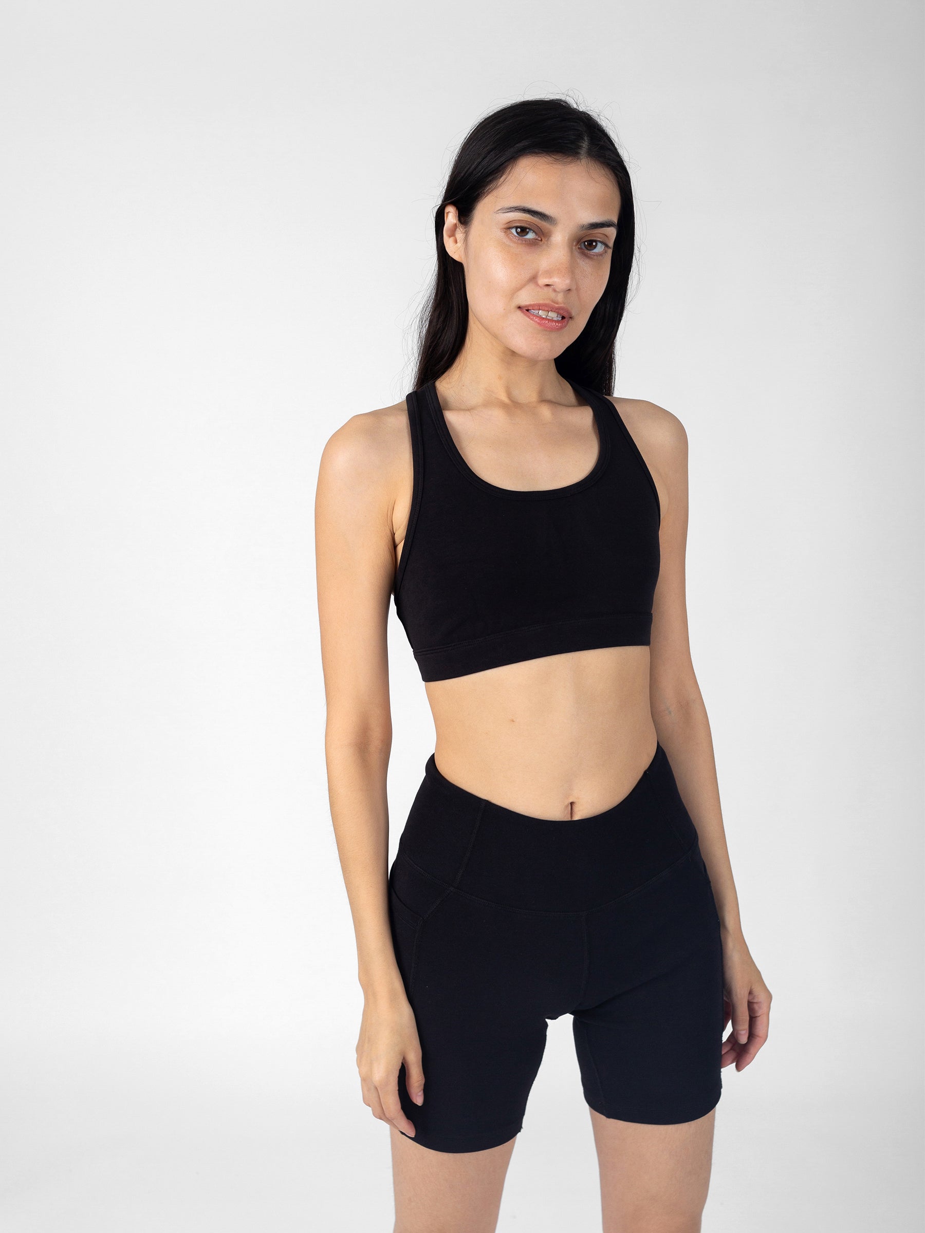 Front view, Eclipse black organic sports bra with bike shorts, racerback silhouette, skin-safe PlantTec fabric
