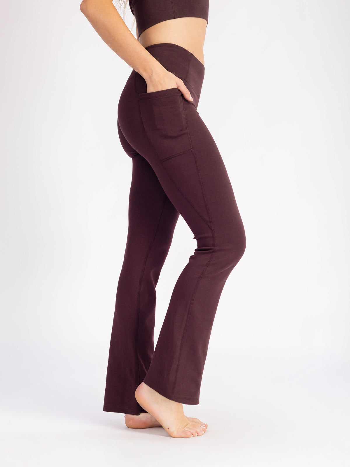 Side view of the Espresso brown PlantTec organic cotton flare leggings, waist to flared hem