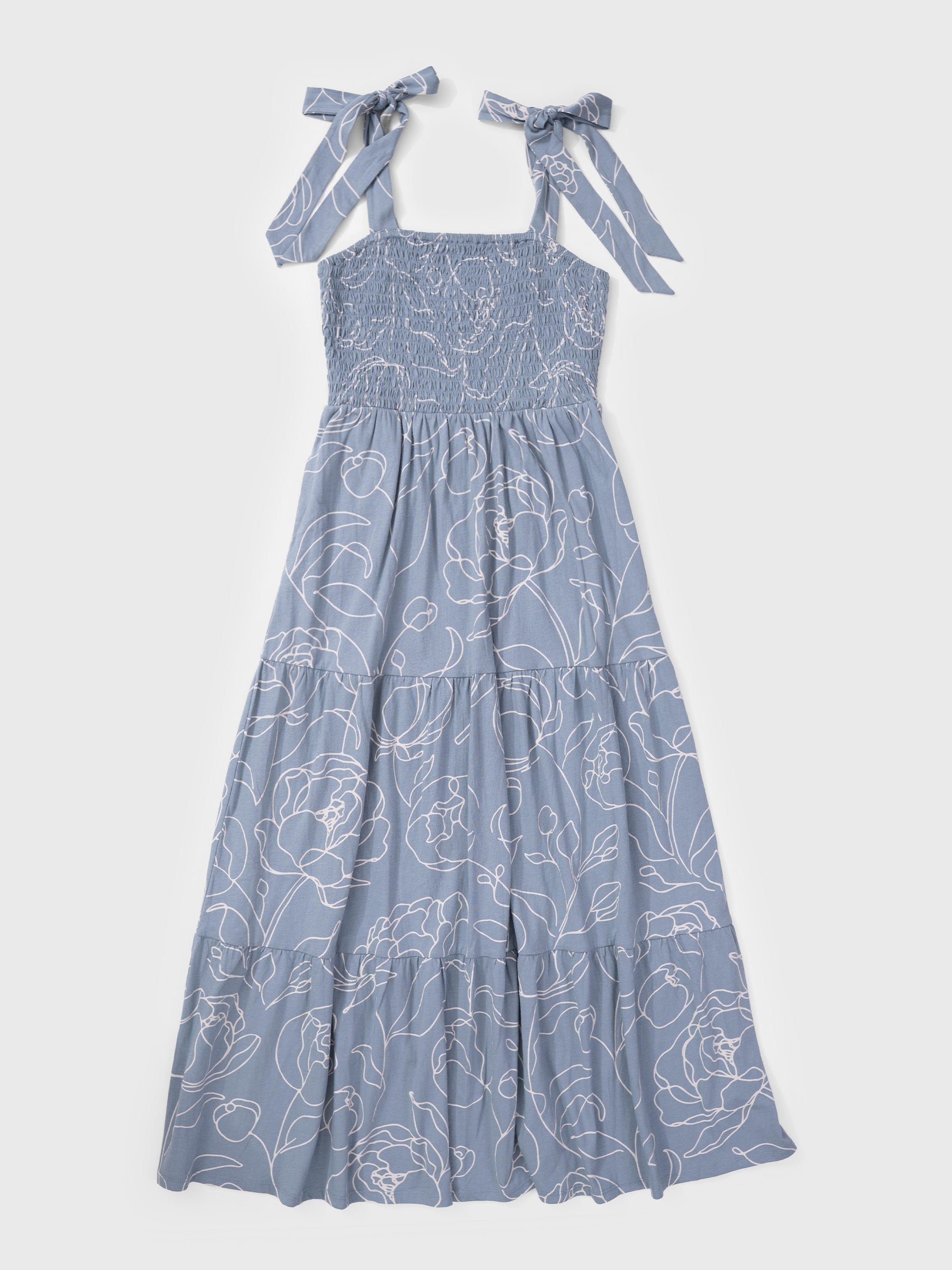 Blue floral dress with ribbon straps on a white background