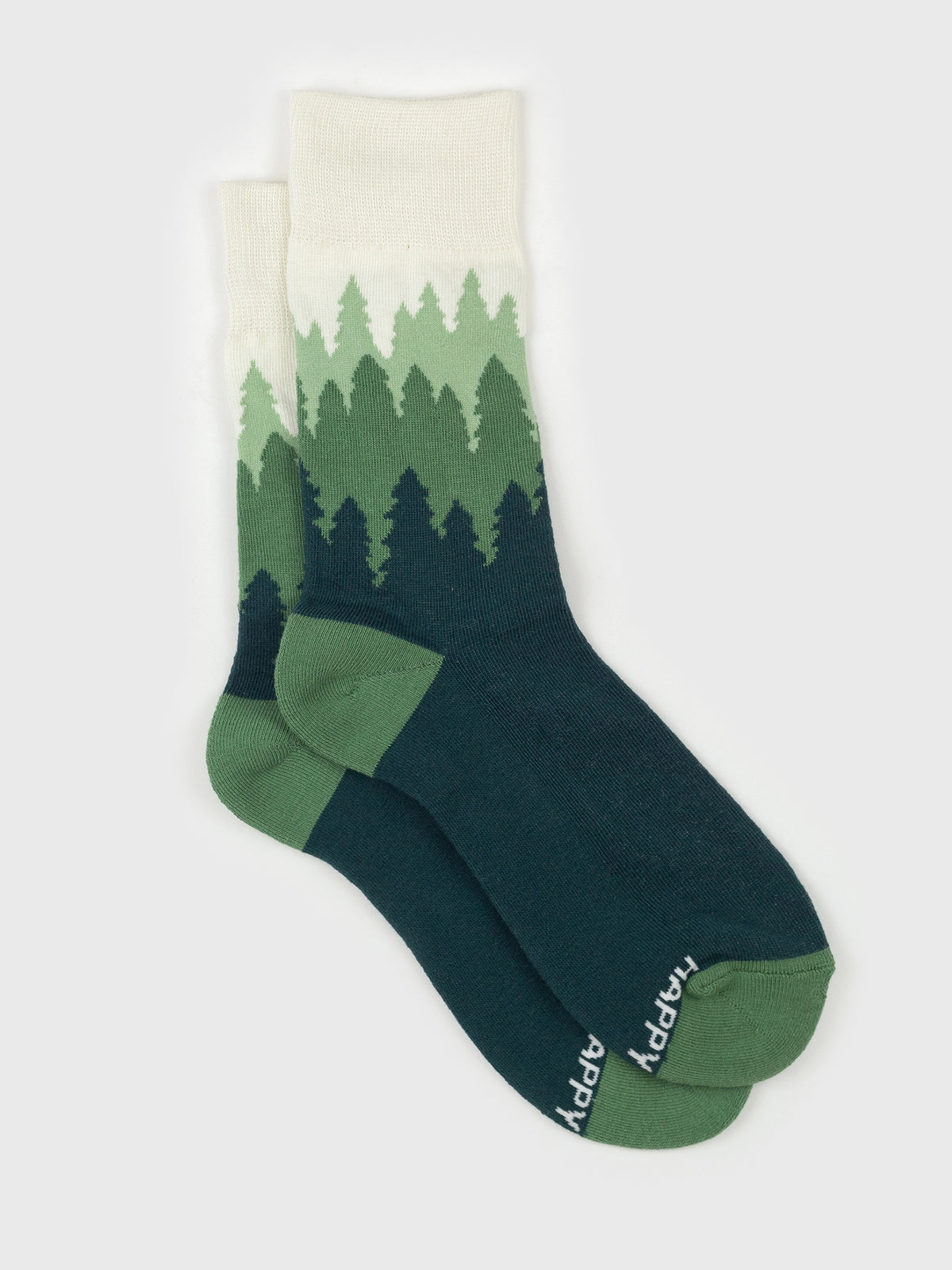 Flat lay of the Treeline organic cotton crew socks, layered green pine forest fading up to a cream cuff