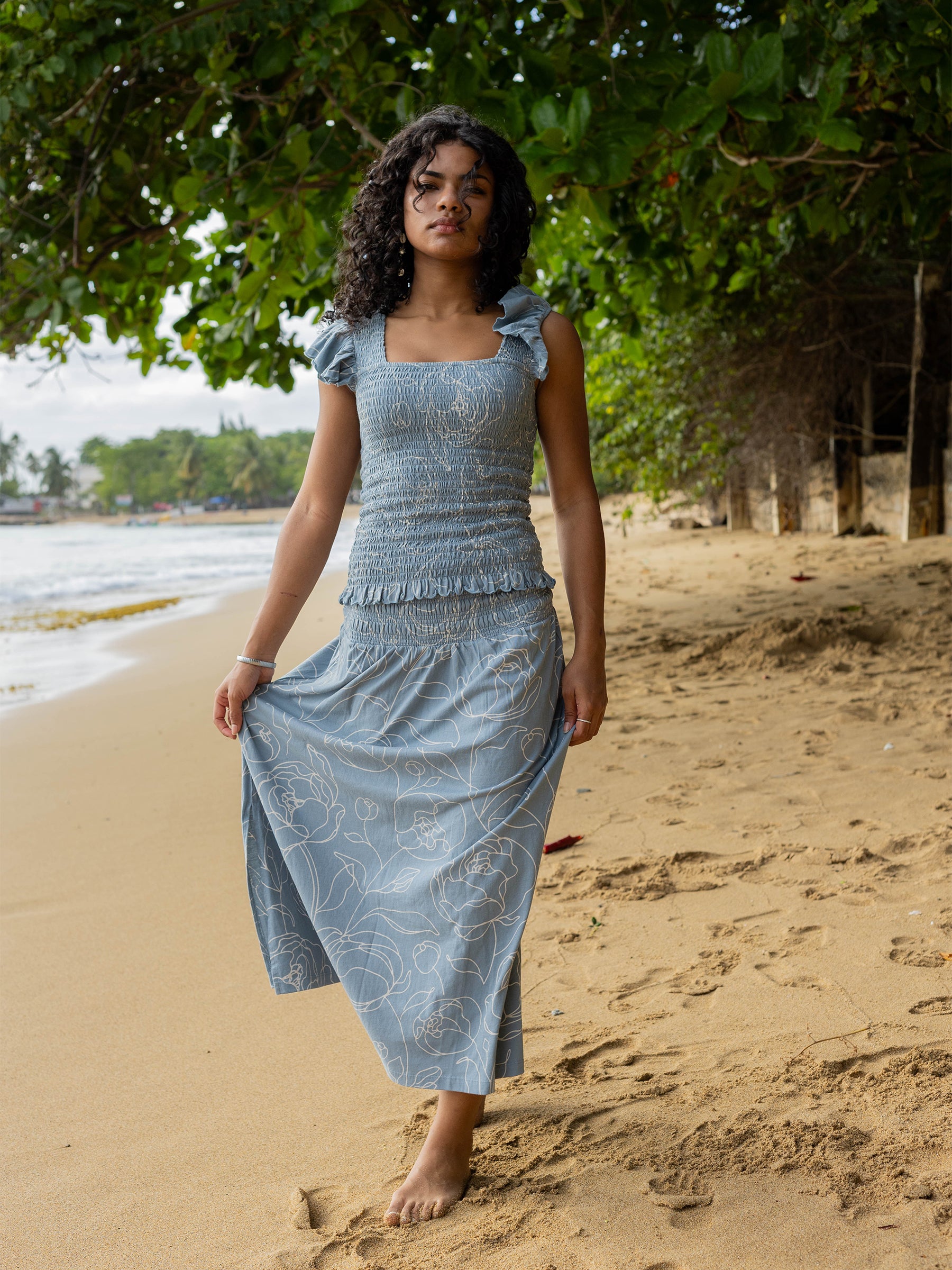 Smocked light blue organic cotton top with flutter sleeves and matching skirt with white rose print.