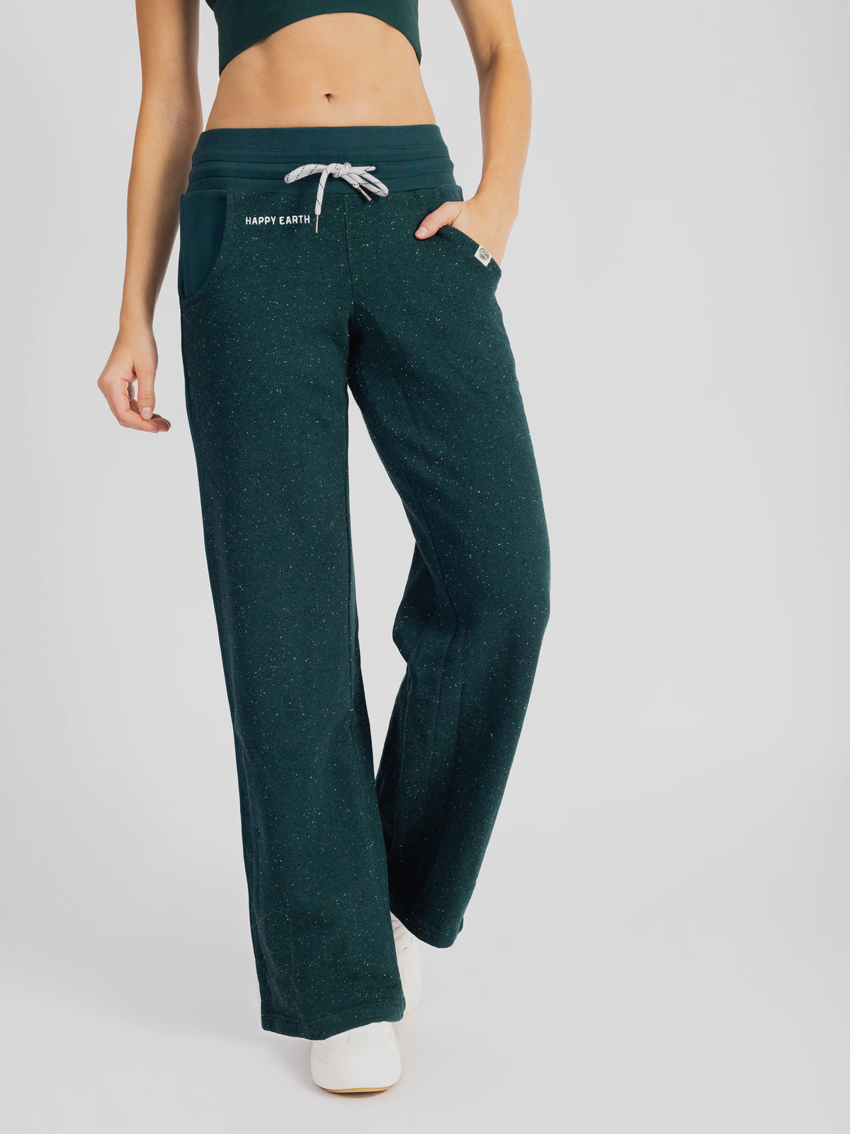 Front of the Monstera teal organic cotton wide leg sweatpants with a sports bra