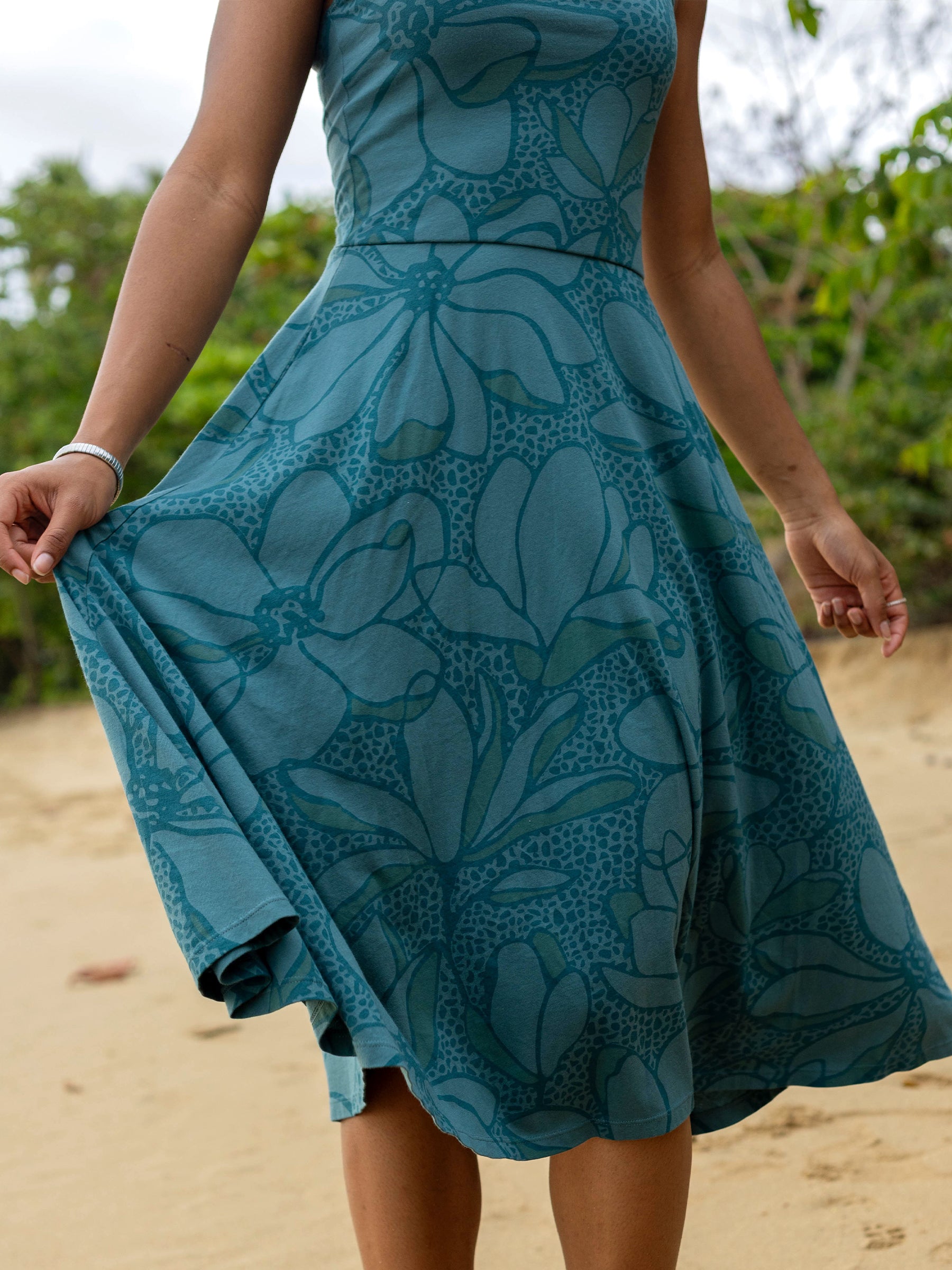 Lily Dress: Teal organic cotton midi dress with large floral print, square neckline, and flowy skirt.