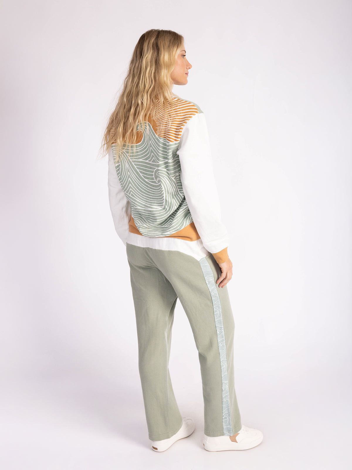 Back view of a model in the Rolling Seas straight leg sweatpants and matching sweatshirt