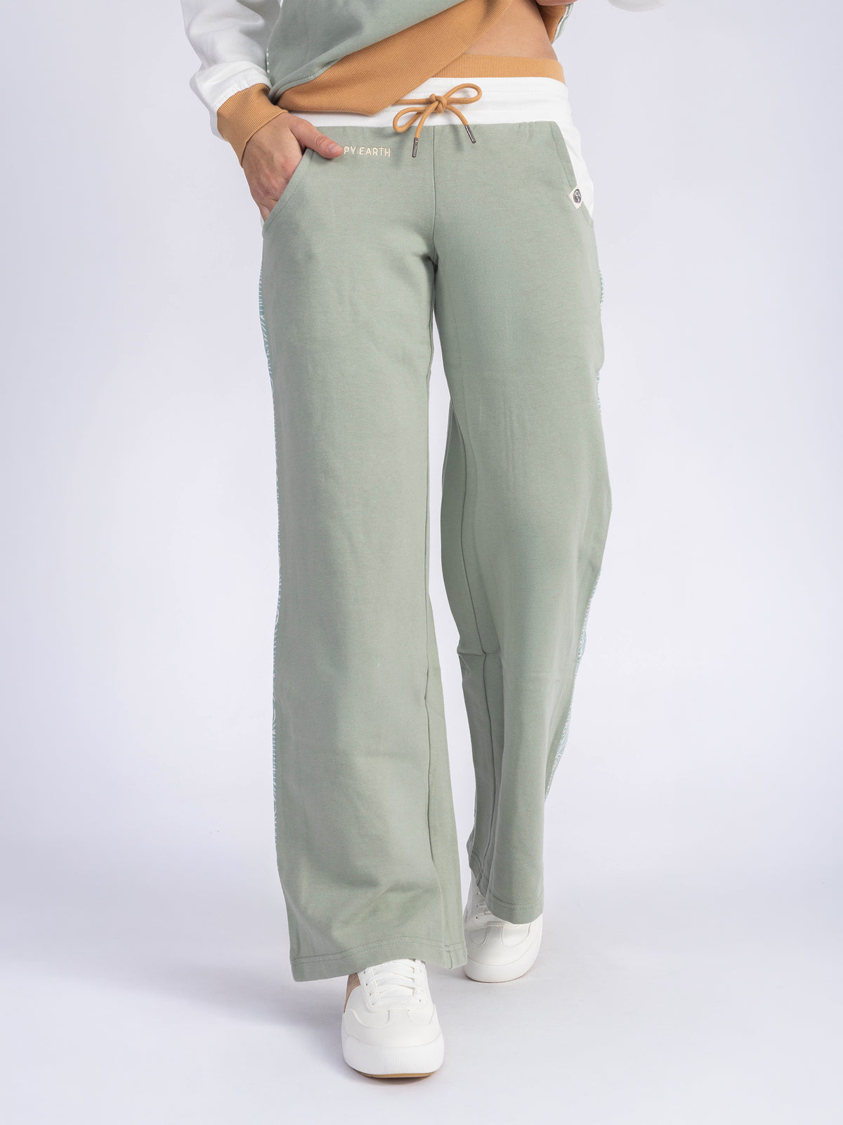 Front of the Rolling Seas organic cotton wide leg sweatpants, hand in pocket