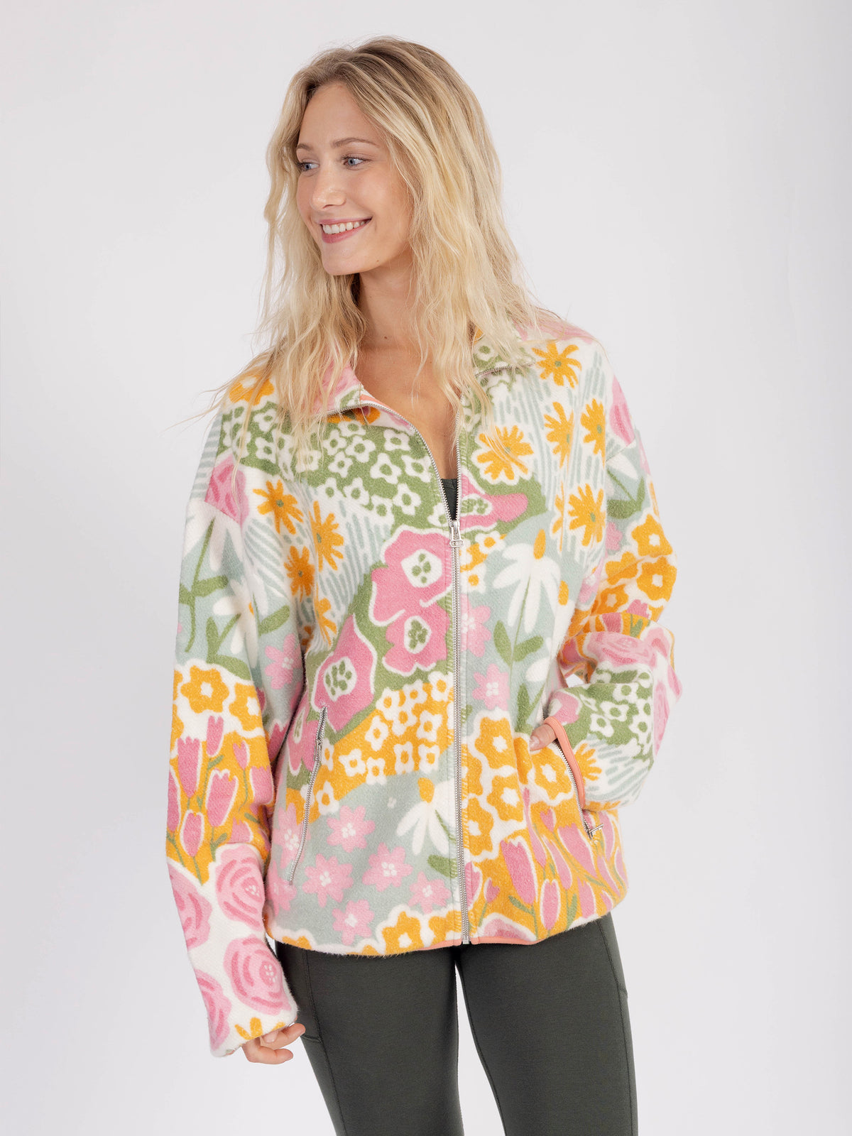 Smiling model wearing the Bouquet organic cotton sherpa jacket, three-quarter view