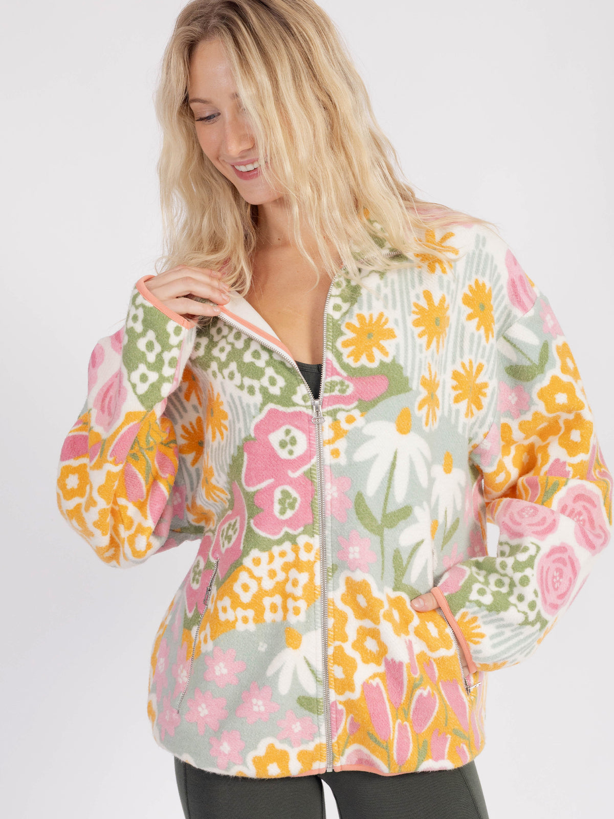 Model zipping up the floral Bouquet organic cotton sherpa jacket