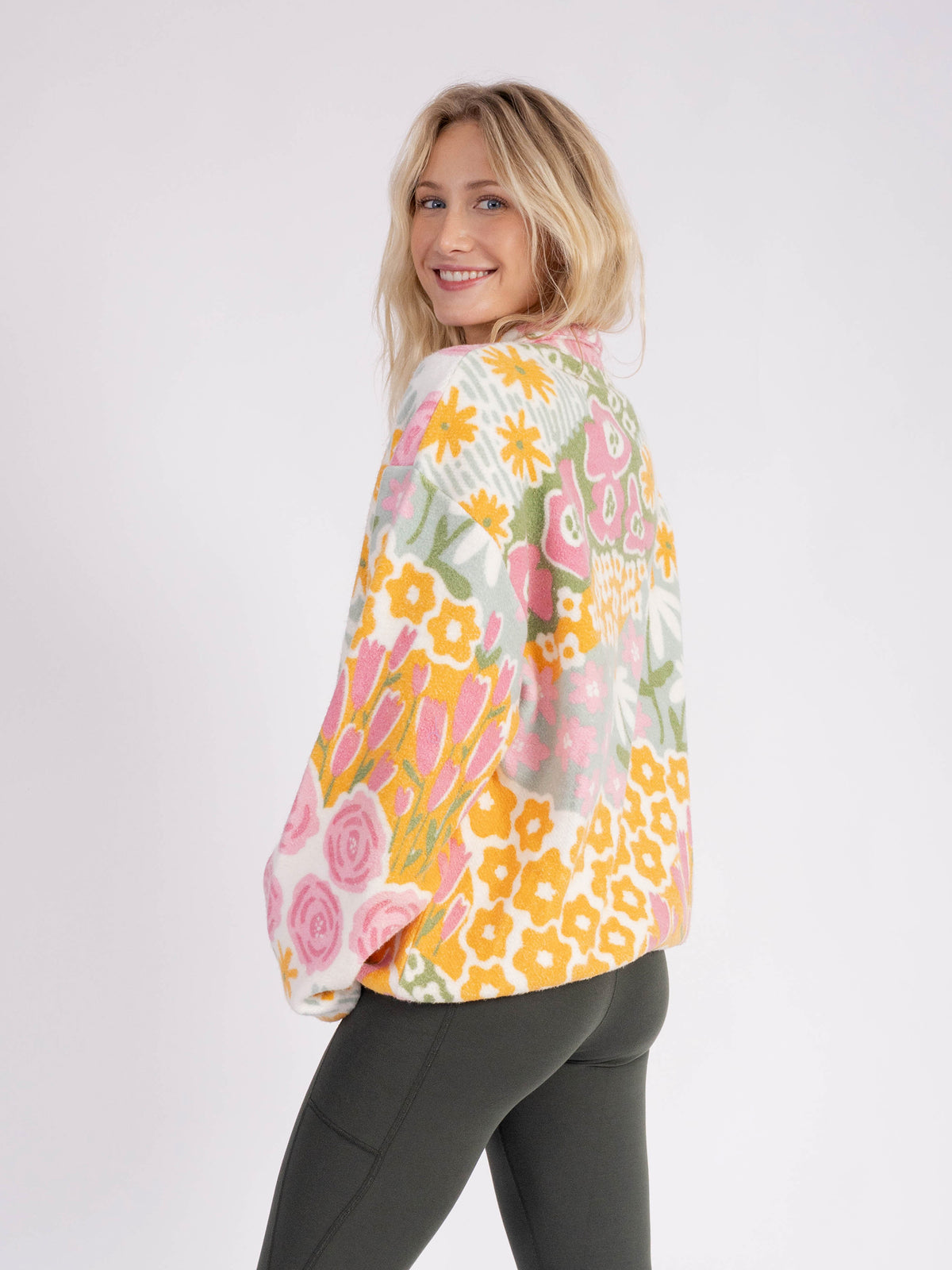 Back view of a model wearing the floral Bouquet organic cotton sherpa jacket