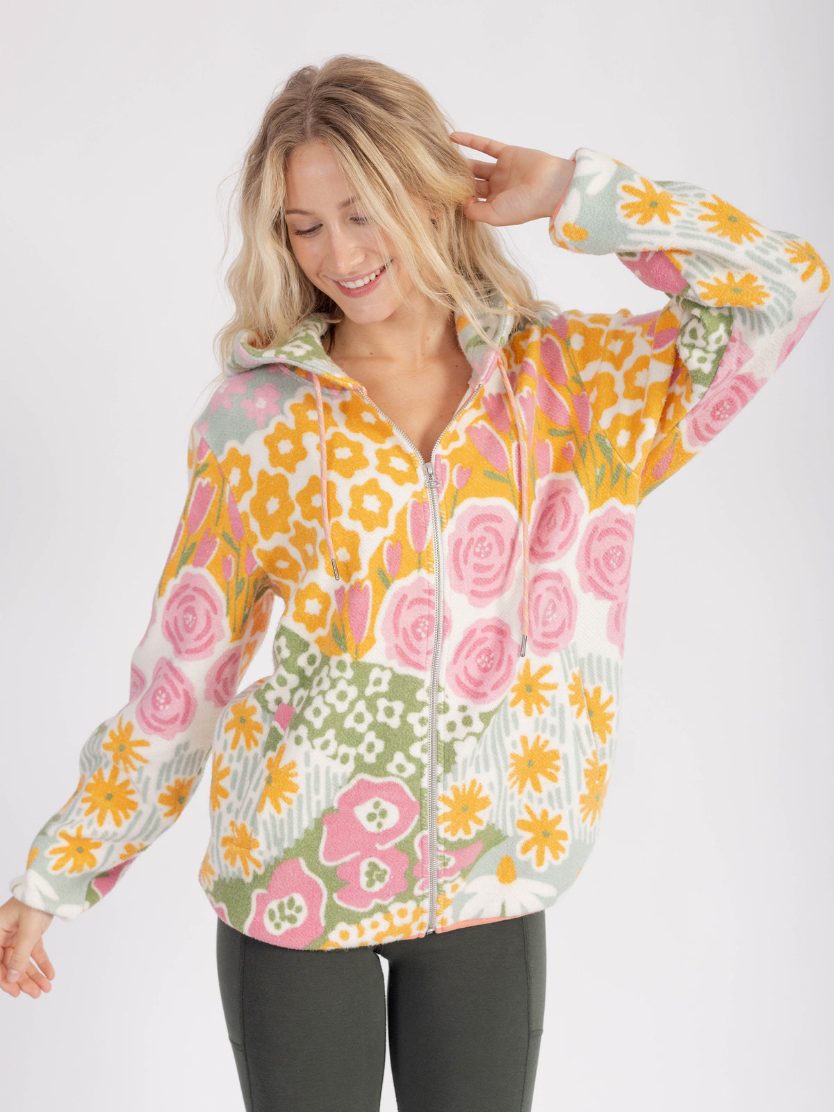 Model wearing the floral Bouquet organic cotton sherpa zip hoodie zipped up, front view