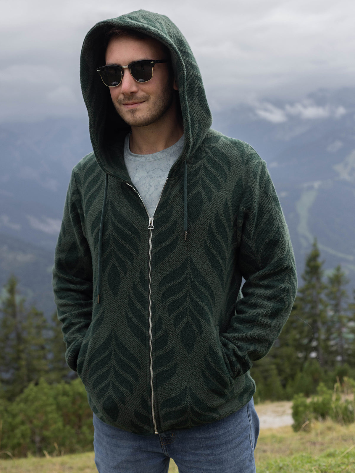 Model wearing the Verdant organic cotton sherpa zip hoodie, hood up, hands in pockets