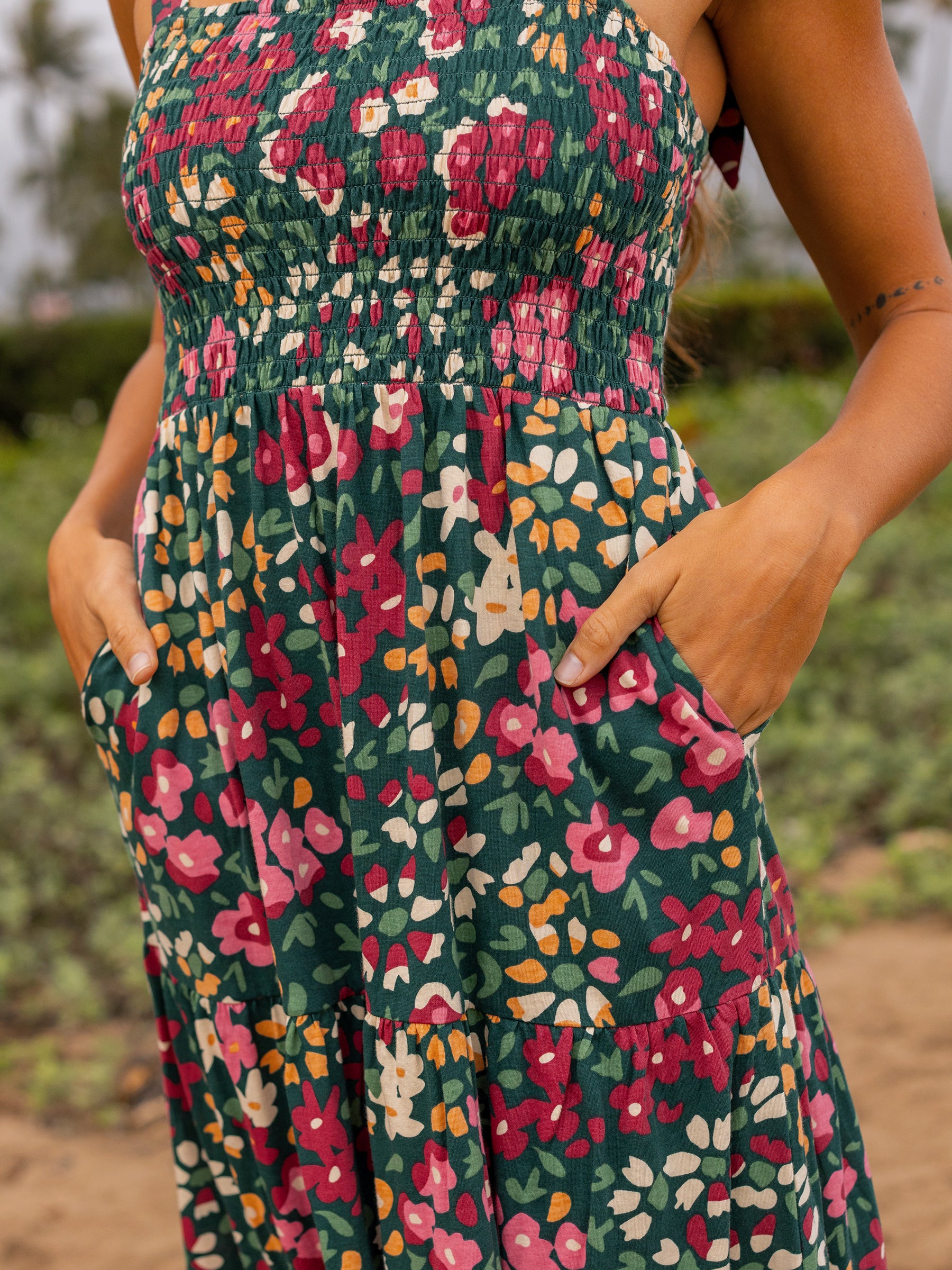 Evie Smocked Dress in Wildflowers print: green maxi with smocked bodice, tiered skirt, and pockets.