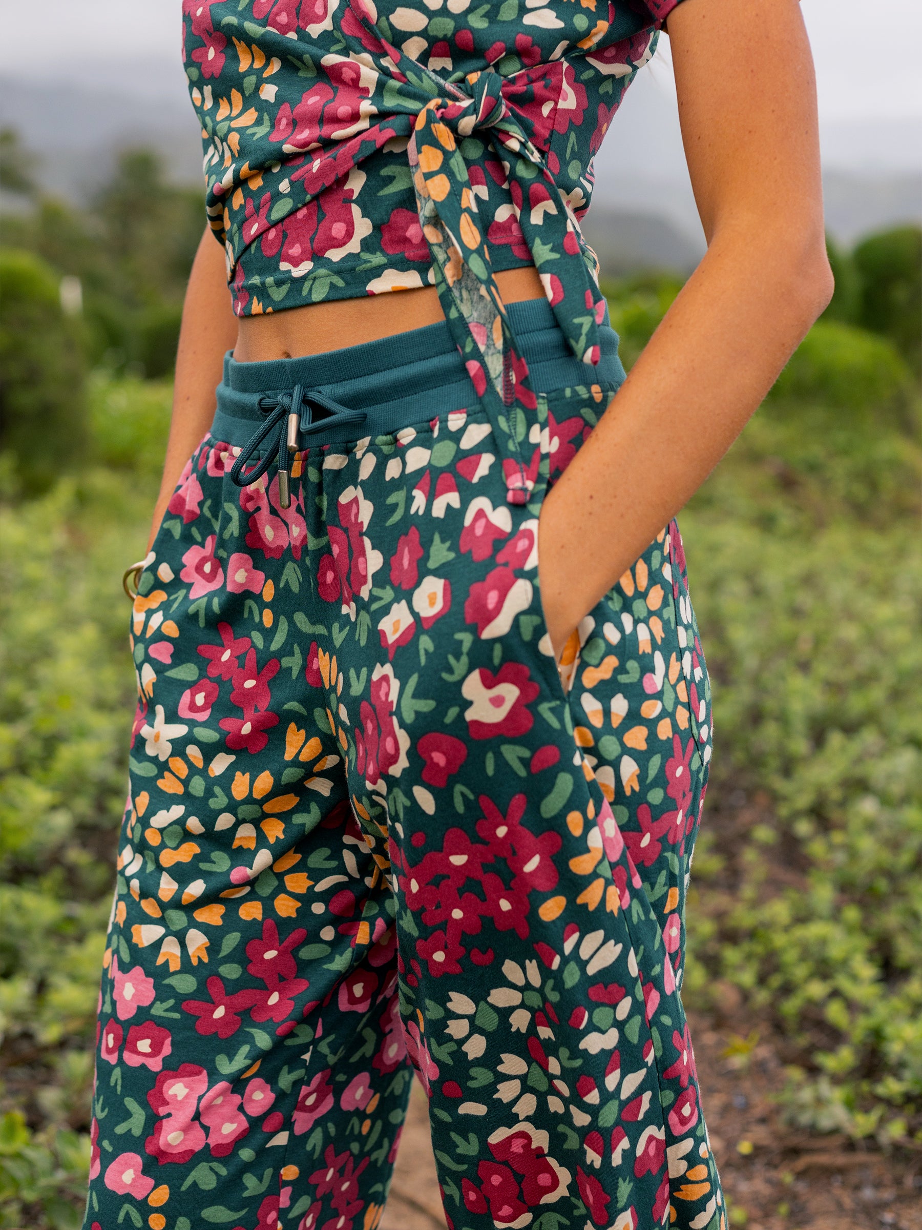 Wide-leg organic cotton pants in a green wildflower print, with a stretchy waistband and pockets.
