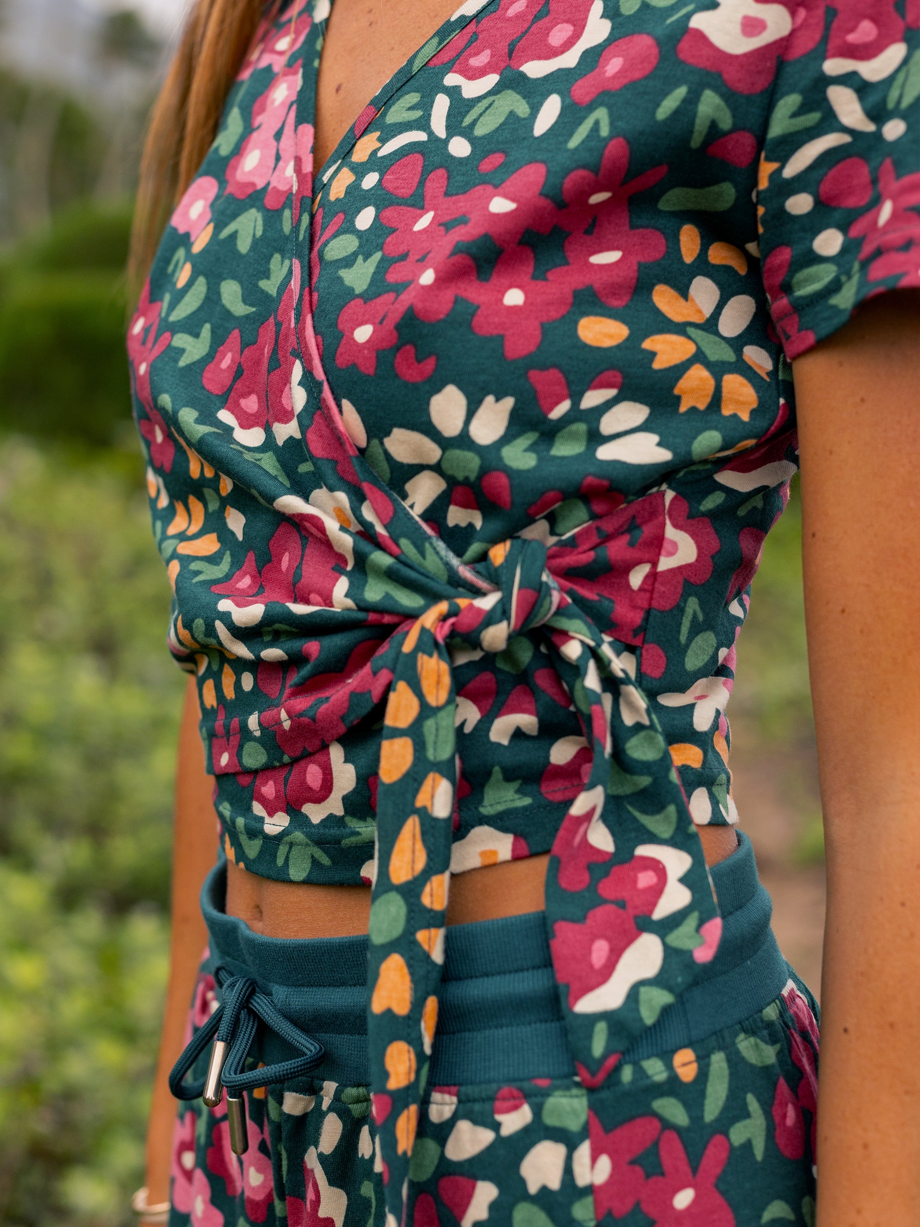 Wildflowers wrap crop top in organic cotton, featuring a V-neck and waist tie.