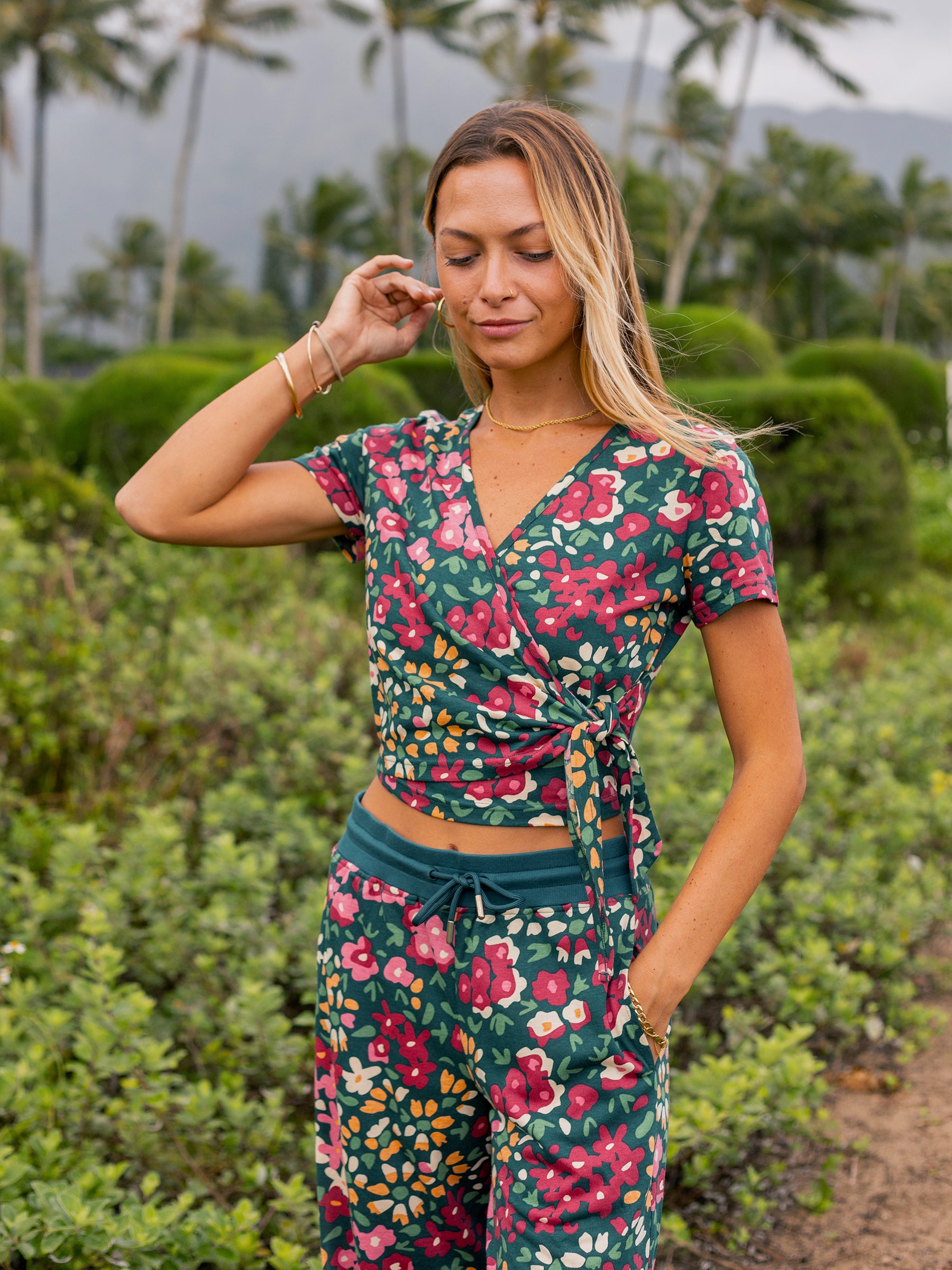 Woman in a Wildflowers print organic cotton wrap crop top and matching pants.