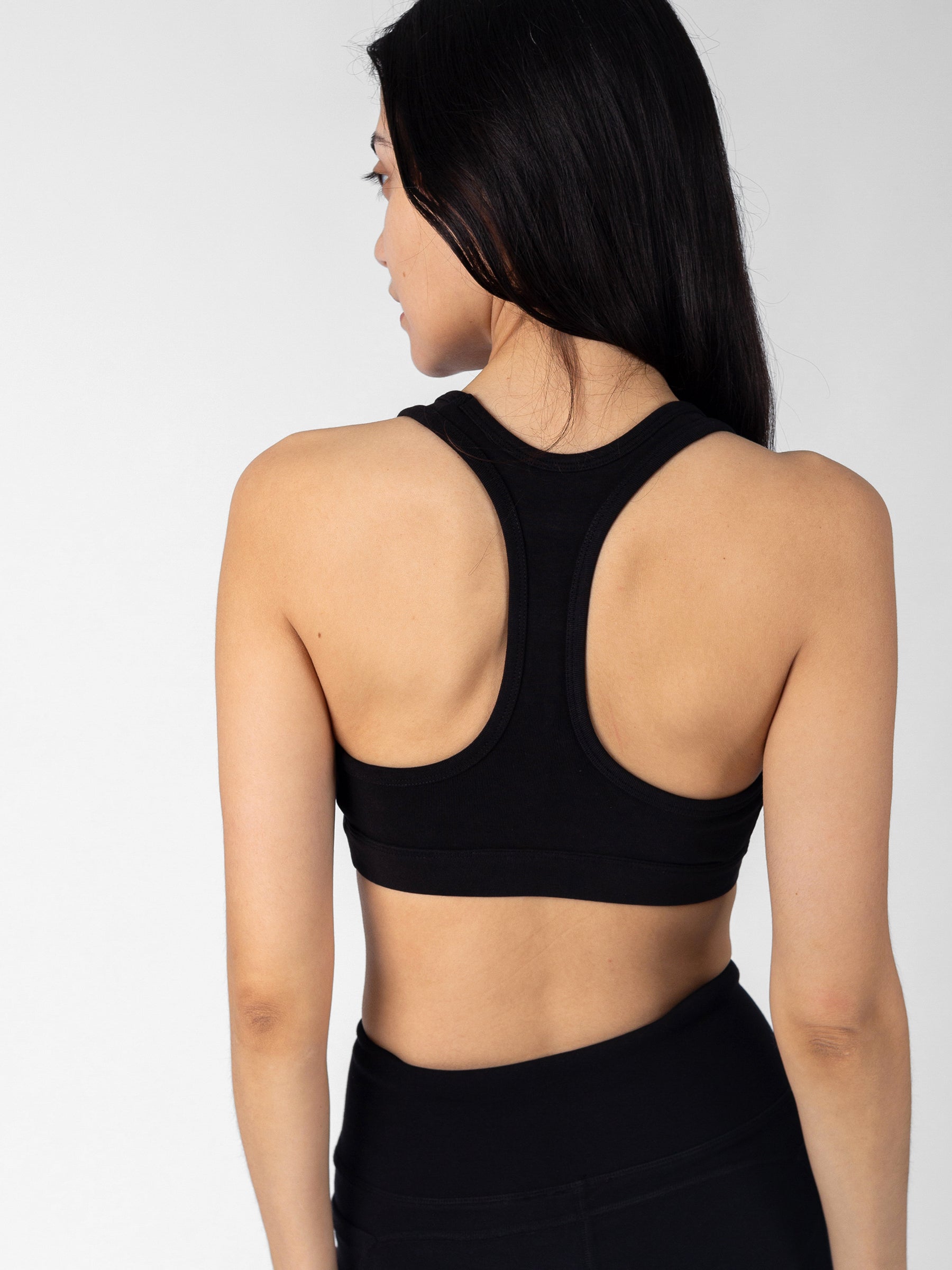 Back view of Eclipse black PlantTec sports bra, classic racerback Y-strap construction, non-toxic organic cotton