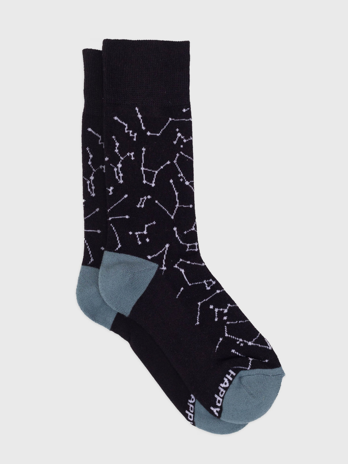 Flat lay of the Constellations organic cotton crew socks, white star constellations on black with slate blue heel and toe