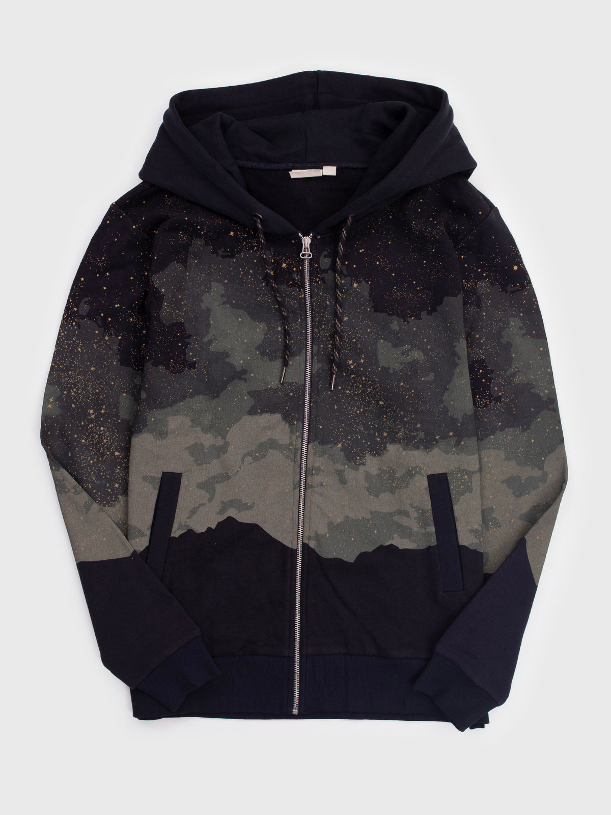 Flat lay of the Embercrest organic cotton zip hoodie in black, starry clouds and mountain silhouette