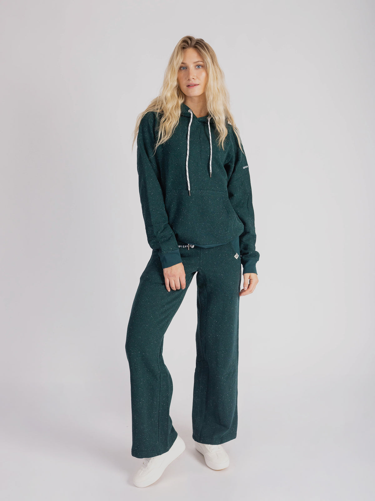 Model wearing the Monstera teal wide leg sweatpants with the matching hoodie, full length