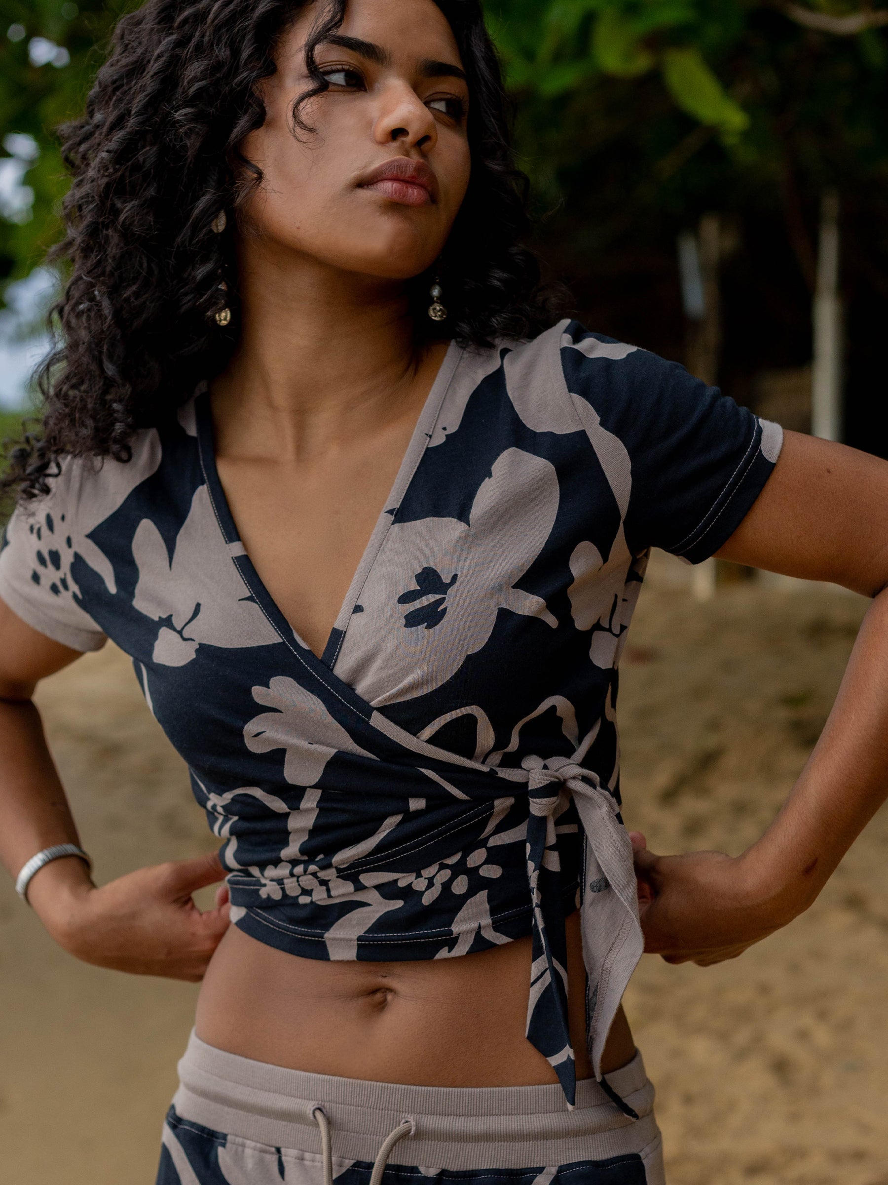 Moonflower Wrap Crop Top in silky organic cotton with black and taupe floral print, v-neck, and waist tie.