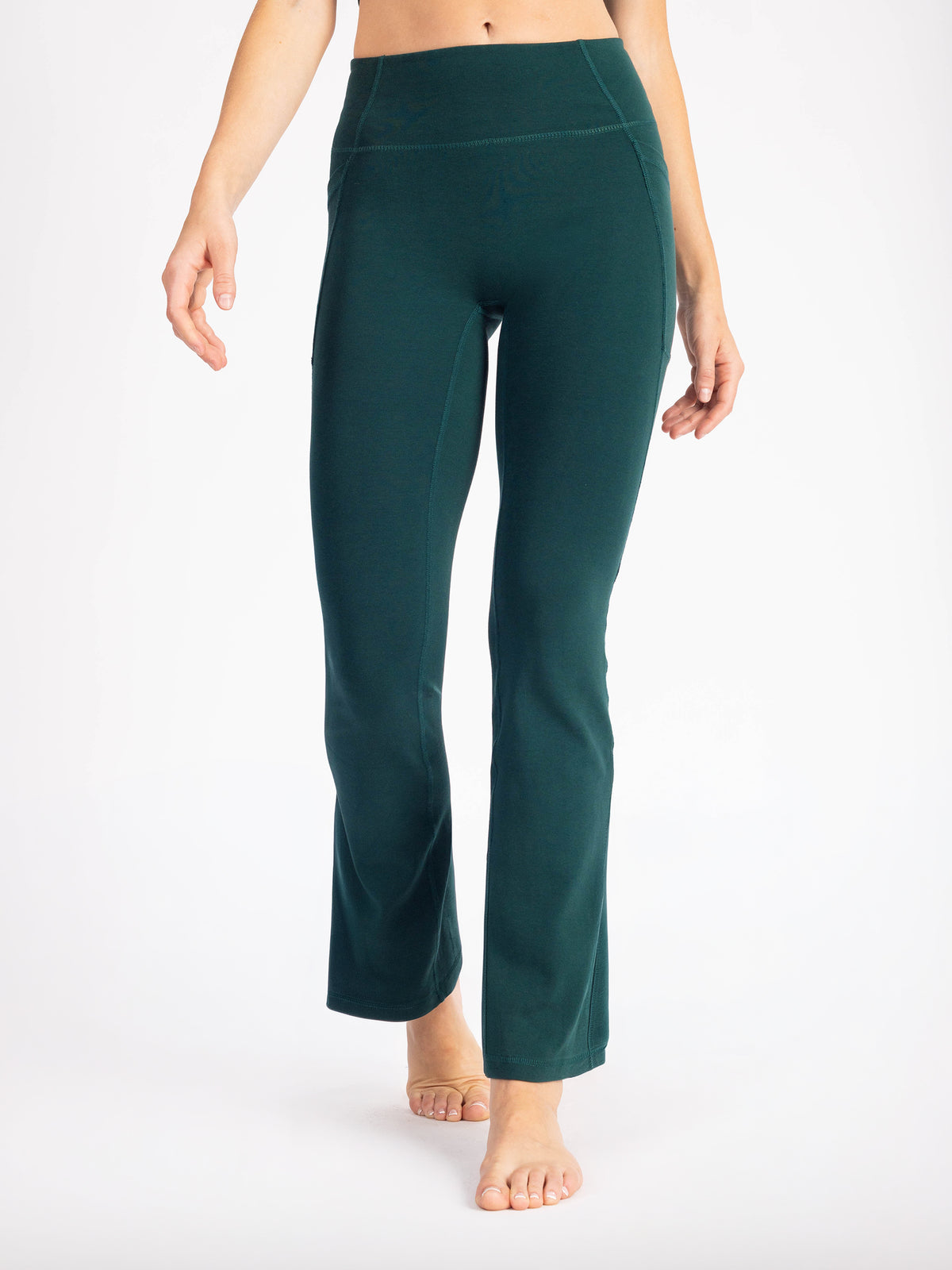 Waist-down front view of the Monstera teal PlantTec organic cotton flare leggings