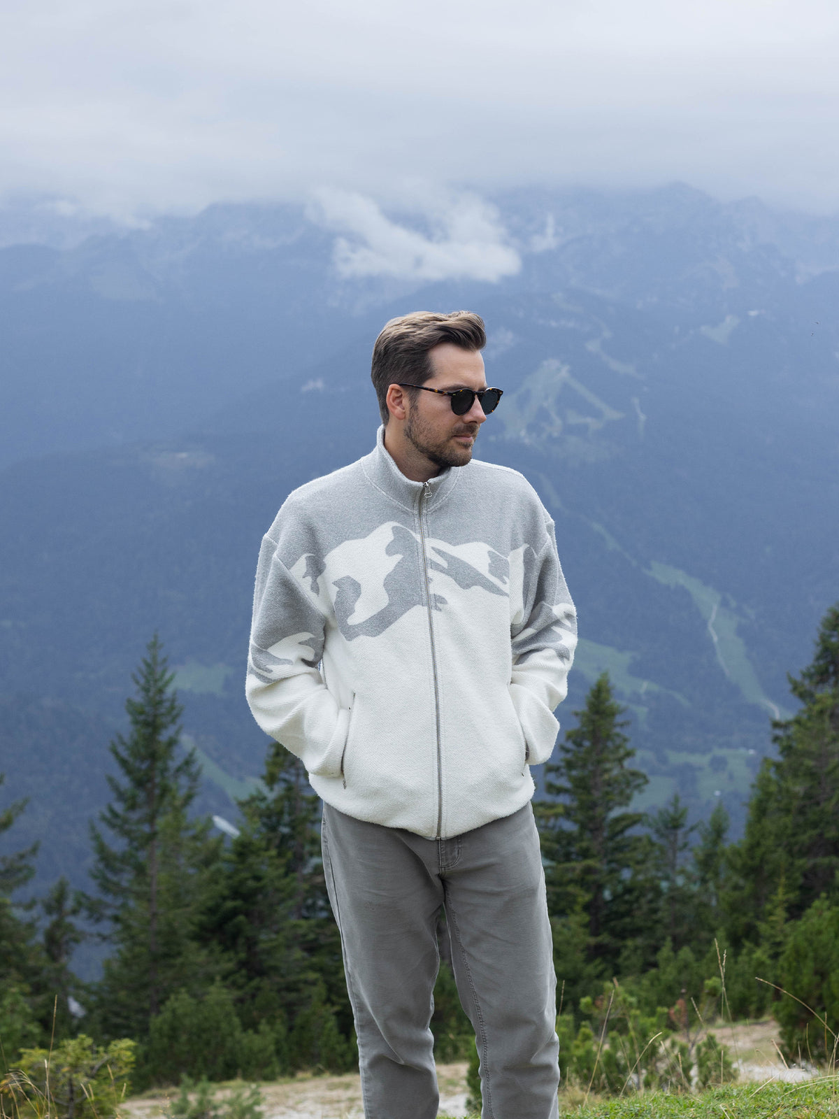 Model wearing the Altitude organic cotton sherpa jacket in front of mountains, full length