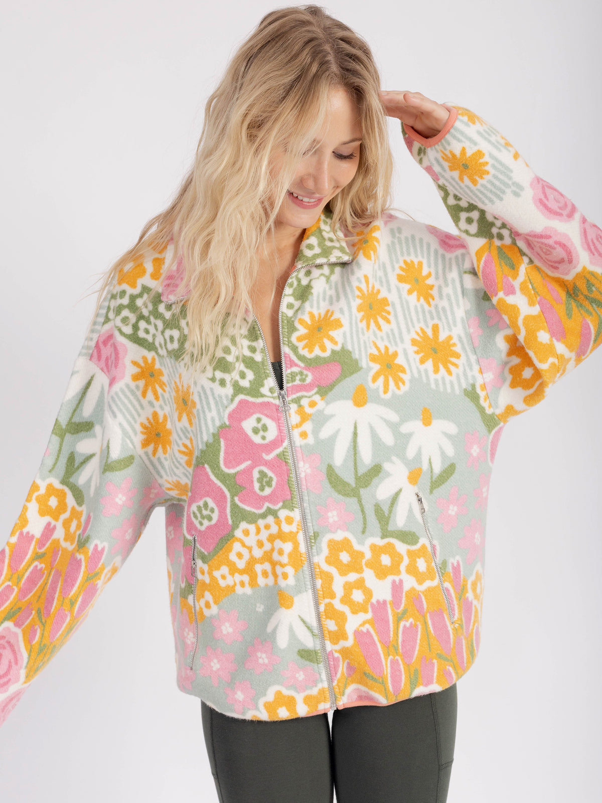 Model wearing the floral Bouquet organic cotton sherpa jacket zipped up