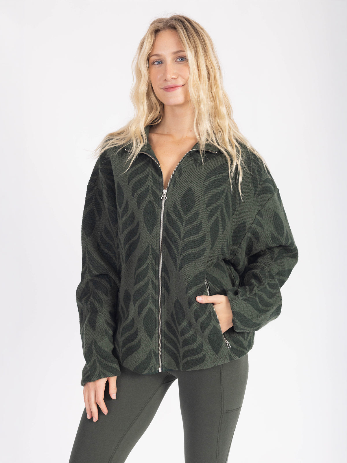 Model wearing the Verdant organic cotton sherpa jacket zipped, hand in pocket
