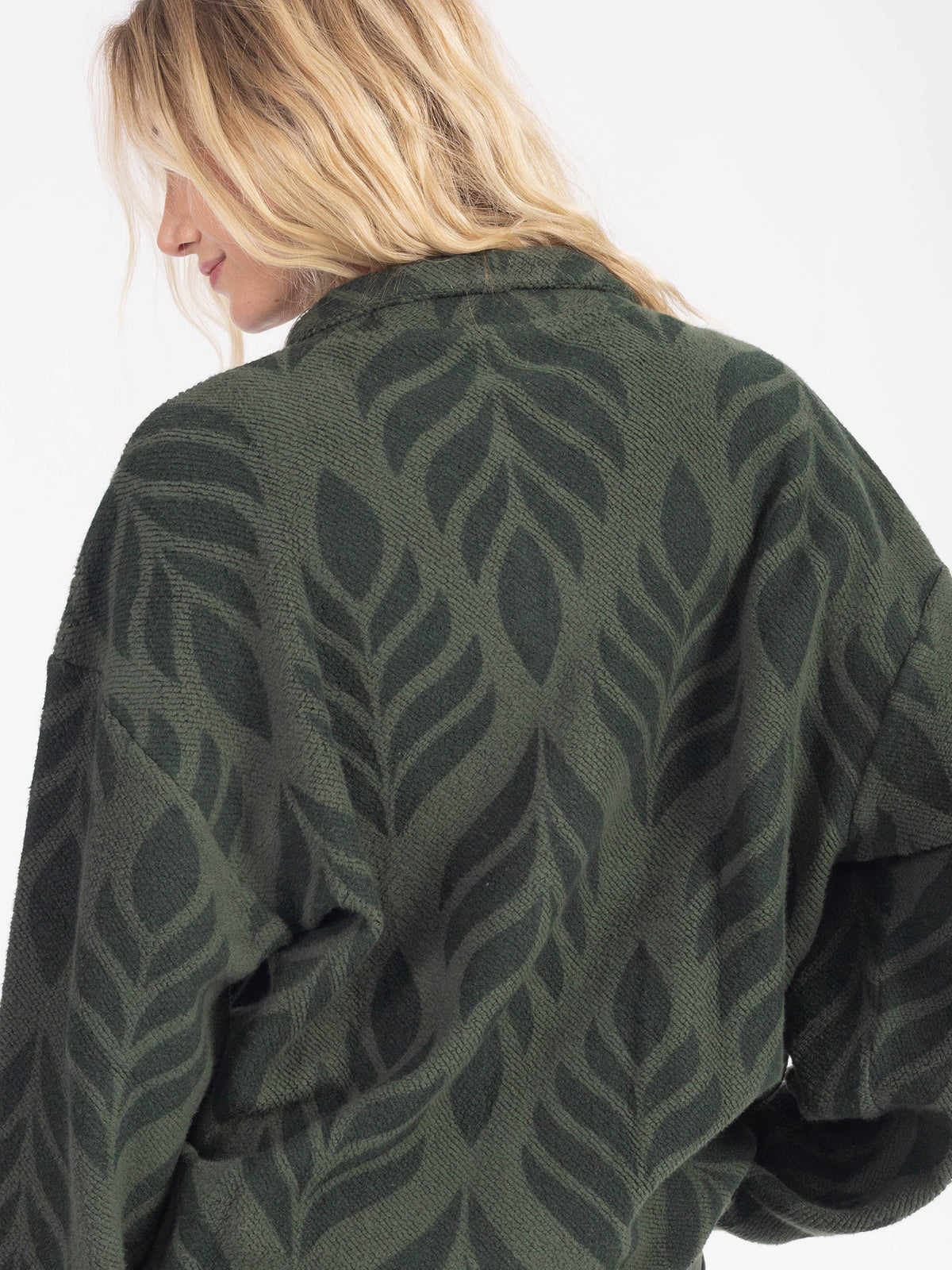 Close-up of the stand collar and tonal leaf pattern on the Verdant organic cotton sherpa jacket