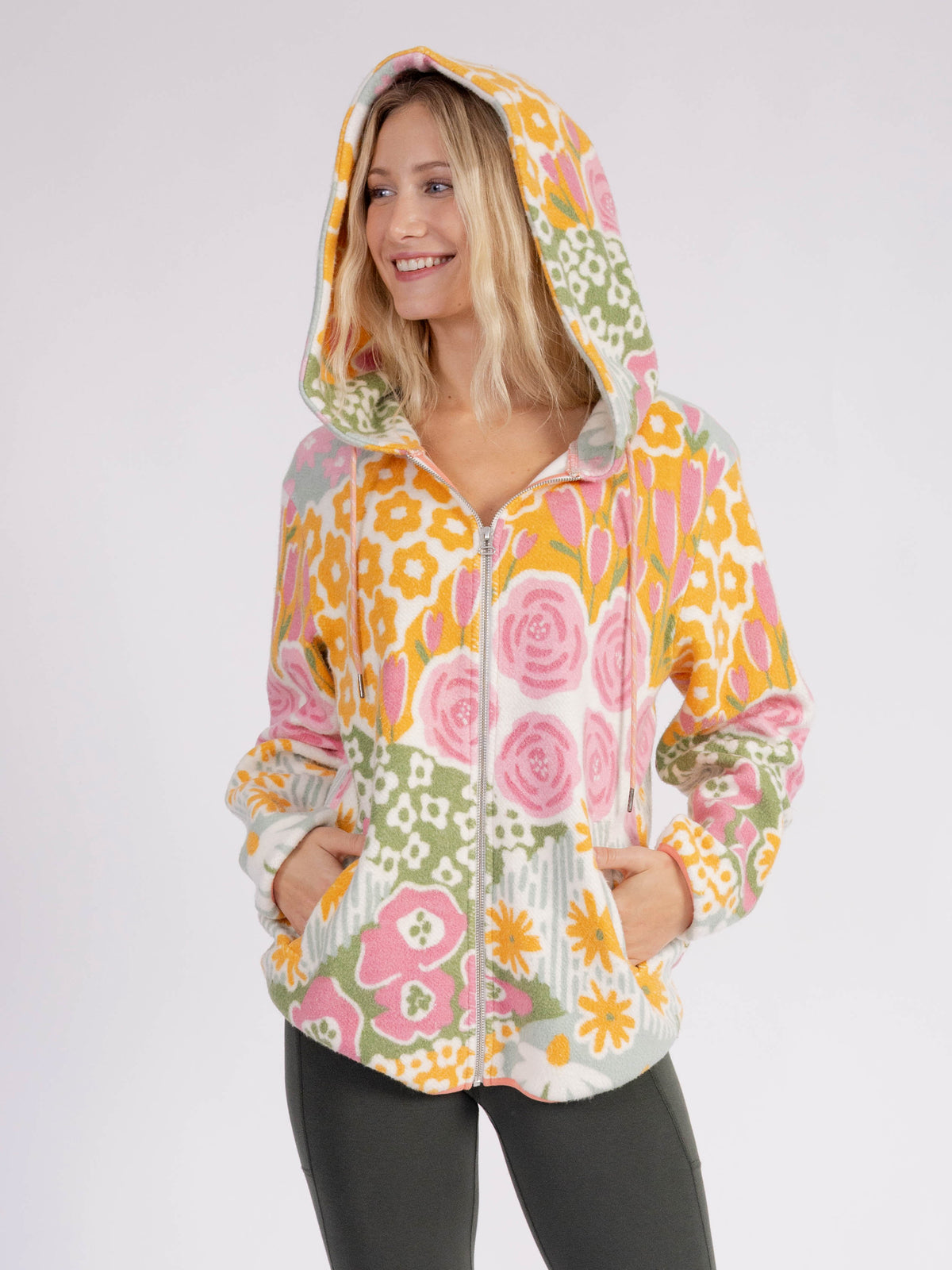 Model wearing the Bouquet organic cotton sherpa zip hoodie, hood up, hands in pockets