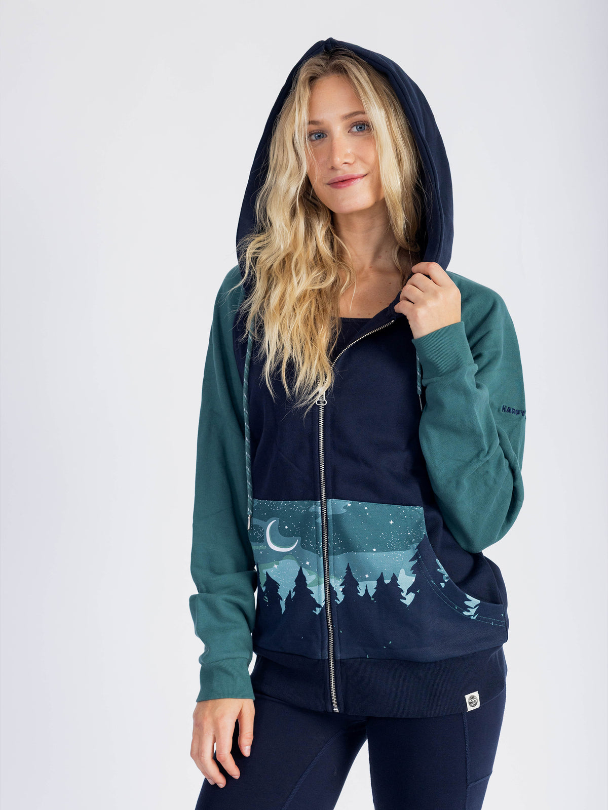 Model wearing the Aurora organic cotton zip hoodie with the hood up
